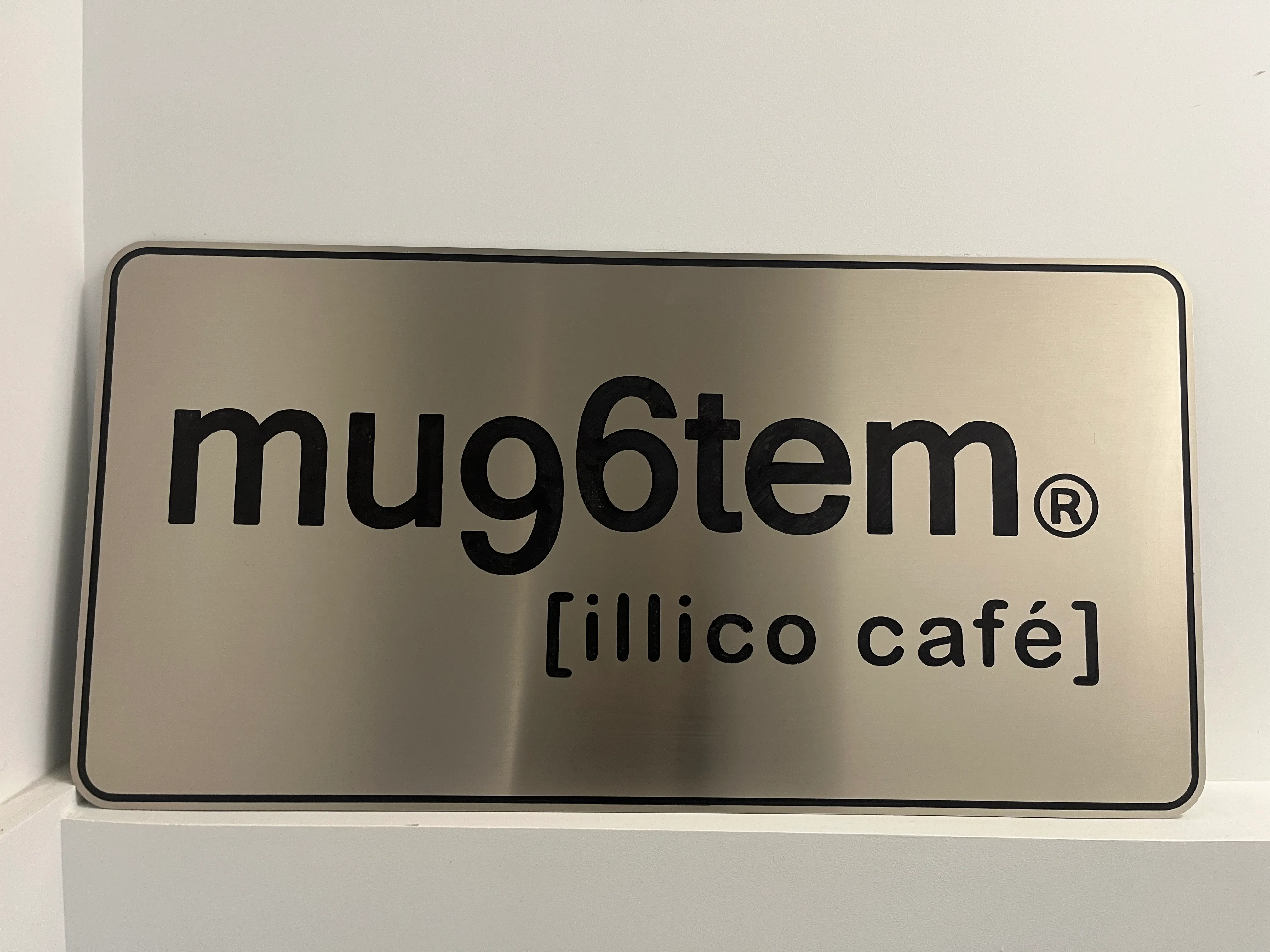The mug6tem [illico café] sign at the office entrance